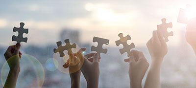iStock-1132265686-ESOP-puzzle-pieces-held-by-hands-horizontal-panoramic